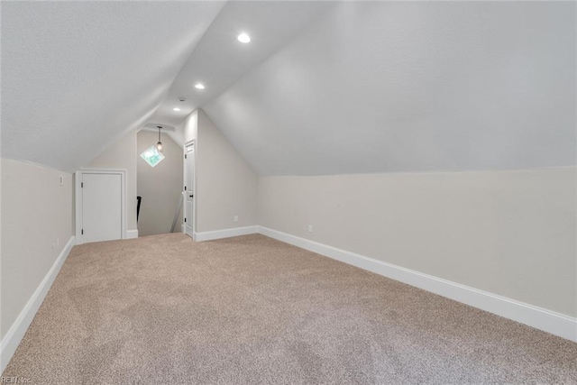 bonus room with lofted ceiling and carpet