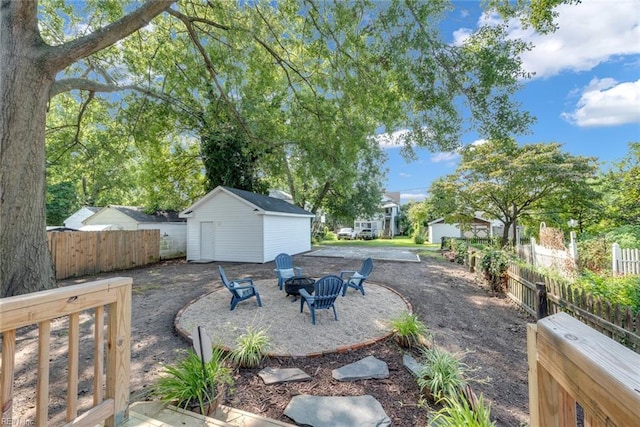 view of patio / terrace with an outdoor fire pit and an outdoor structure