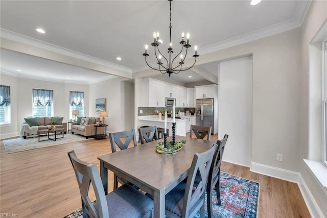 dining space featuring an inviting chandelier, crown molding, and light wood-type flooring