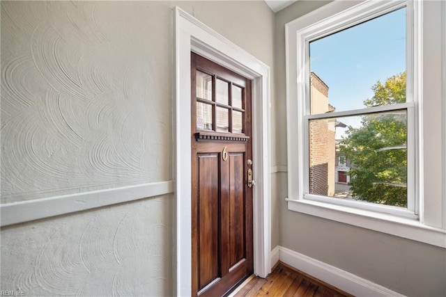 doorway to outside with light wood-type flooring