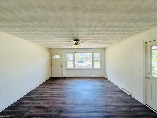 entryway featuring ceiling fan, dark wood-type flooring, and a healthy amount of sunlight