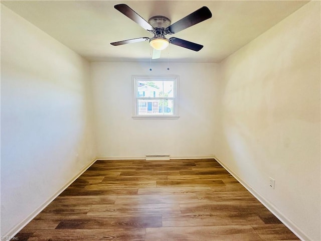 unfurnished room with hardwood / wood-style flooring, ceiling fan, and baseboard heating