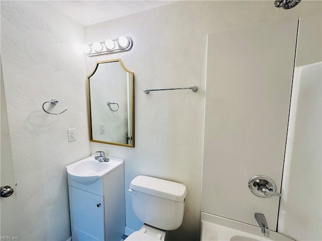 full bathroom featuring vanity, toilet, and washtub / shower combination