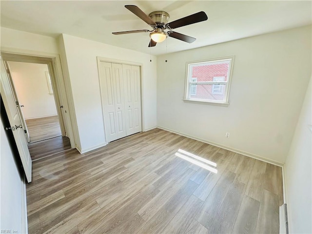 unfurnished bedroom with a closet, ceiling fan, and light hardwood / wood-style flooring