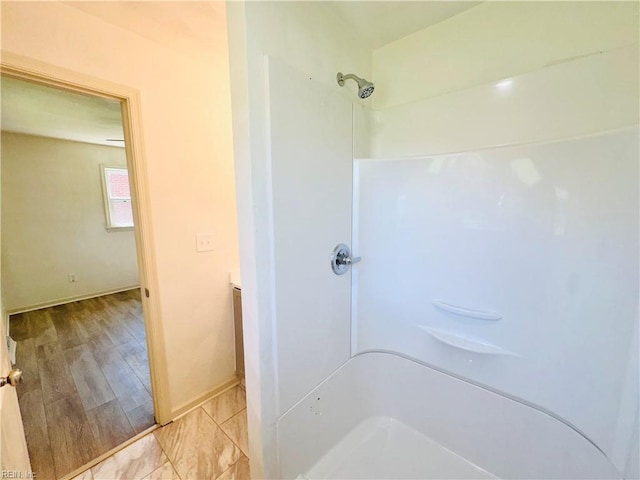 bathroom with hardwood / wood-style flooring and walk in shower