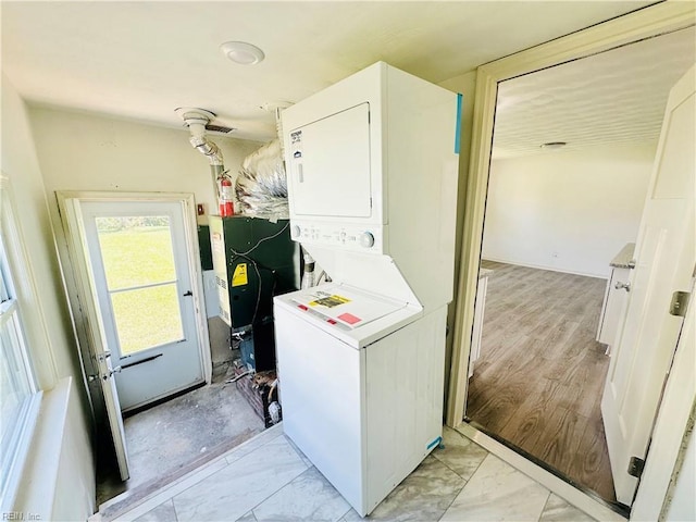 laundry room with stacked washer and dryer