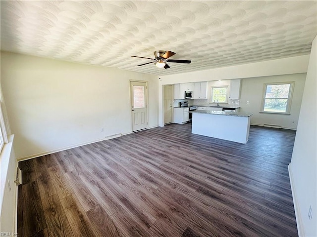 kitchen featuring sink, white cabinetry, appliances with stainless steel finishes, dark hardwood / wood-style flooring, and ceiling fan