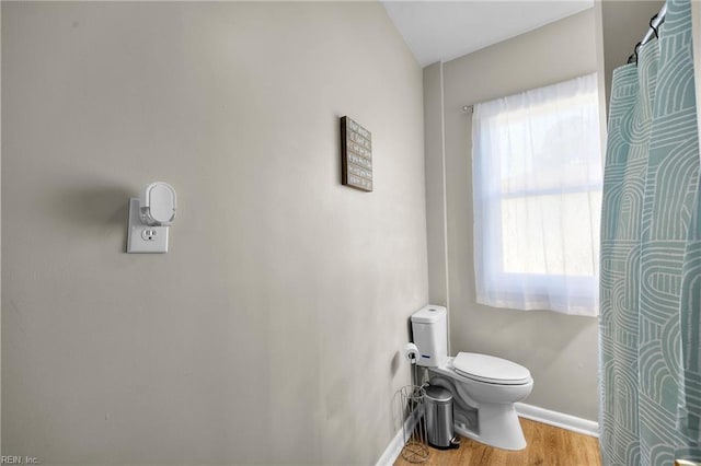 bathroom featuring hardwood / wood-style flooring and toilet