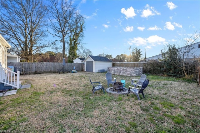 view of yard featuring an outdoor fire pit and a shed