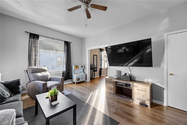 living room featuring hardwood / wood-style flooring and ceiling fan