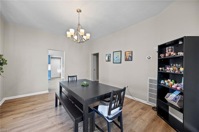 dining area featuring a chandelier and light hardwood / wood-style floors