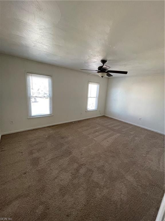 carpeted empty room featuring ceiling fan