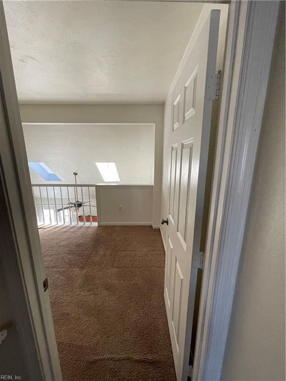 corridor with dark colored carpet