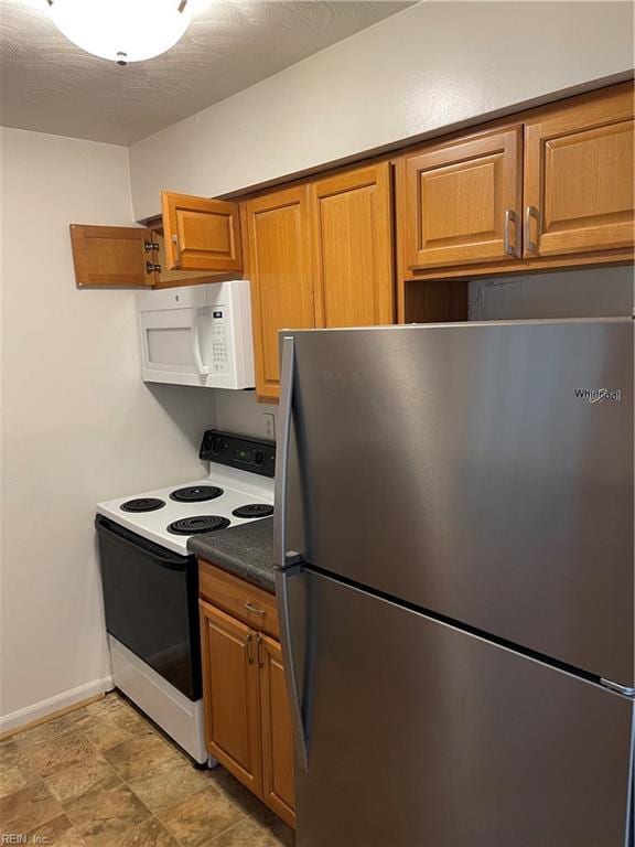 kitchen featuring stainless steel refrigerator and electric stove