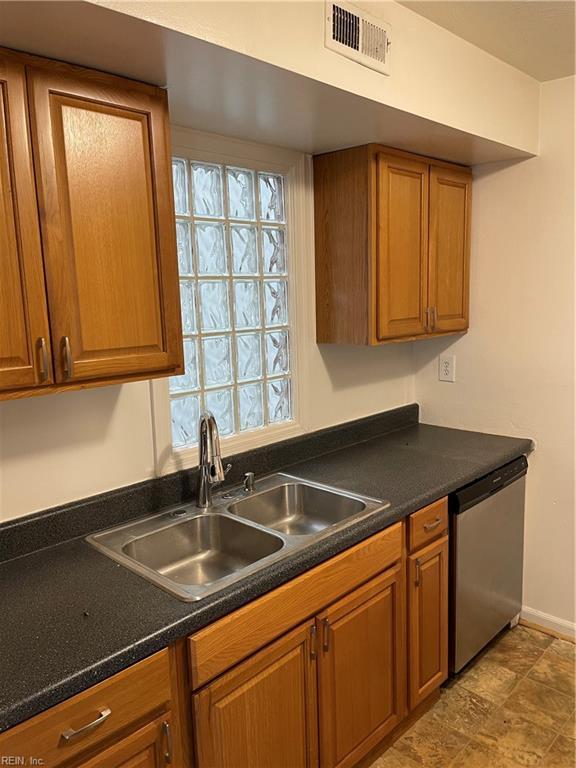 kitchen with a wealth of natural light, sink, and stainless steel dishwasher