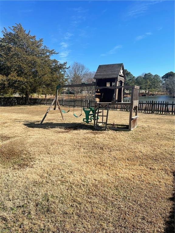 view of playground with a lawn and a water view