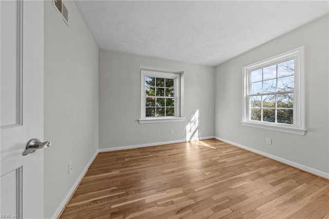 spare room with light wood-type flooring