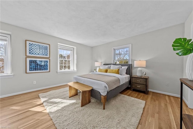 bedroom featuring multiple windows and light wood-type flooring