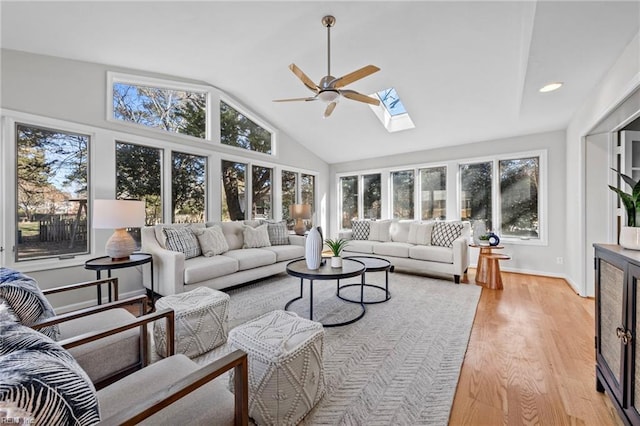 sunroom / solarium featuring ceiling fan and vaulted ceiling with skylight