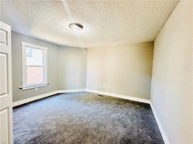 unfurnished room featuring carpet floors and a textured ceiling