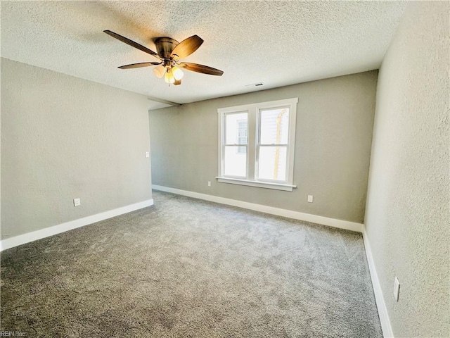 carpeted empty room featuring ceiling fan and a textured ceiling