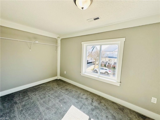 unfurnished bedroom featuring a closet, a textured ceiling, and carpet