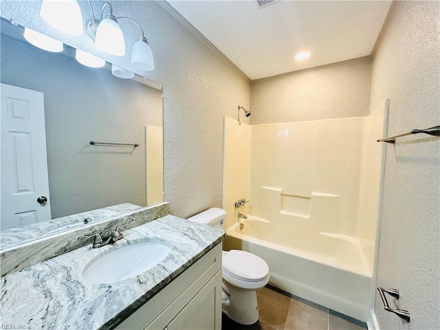 full bathroom with vanity, tile patterned floors, washtub / shower combination, and toilet