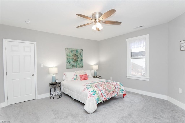 bedroom with ceiling fan and light carpet