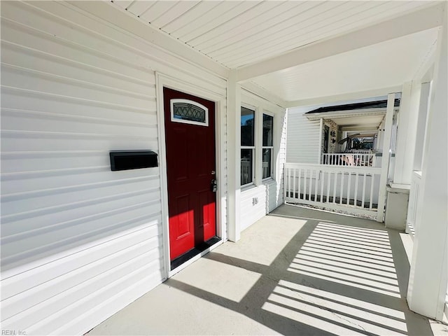 view of exterior entry with a porch