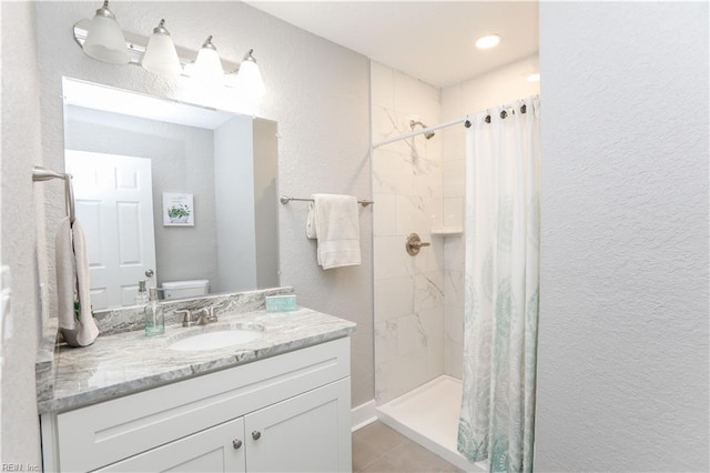 bathroom with vanity, toilet, curtained shower, and tile patterned flooring