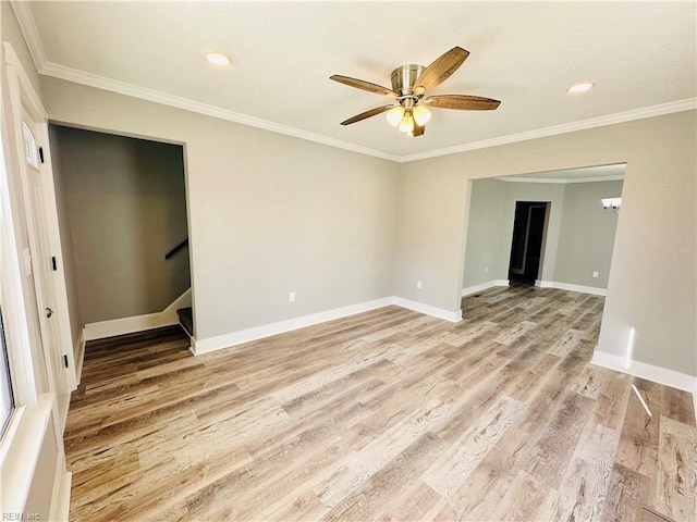 spare room featuring crown molding, ceiling fan, and light hardwood / wood-style flooring