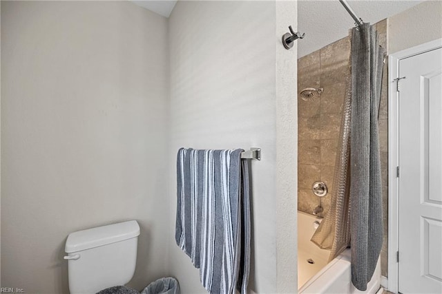 bathroom featuring shower / tub combo with curtain and toilet