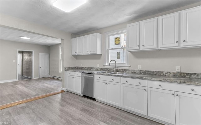 kitchen with a baseboard radiator, sink, white cabinets, stainless steel dishwasher, and light wood-type flooring