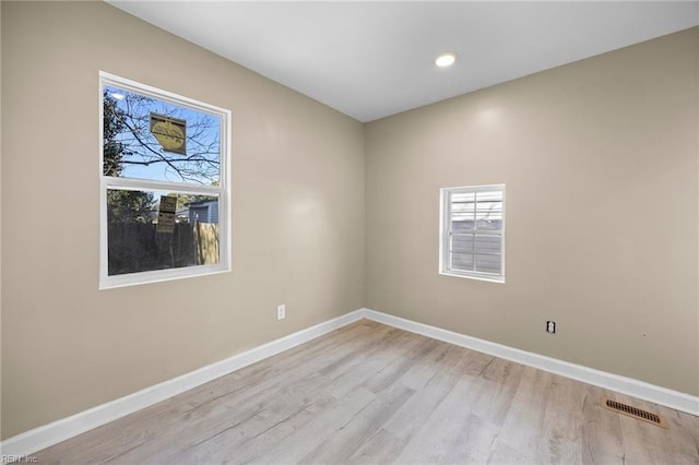 spare room featuring light hardwood / wood-style flooring