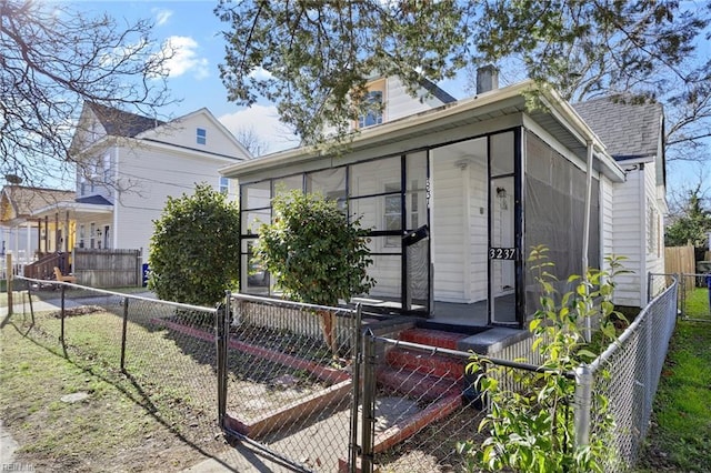 view of front of property with a sunroom