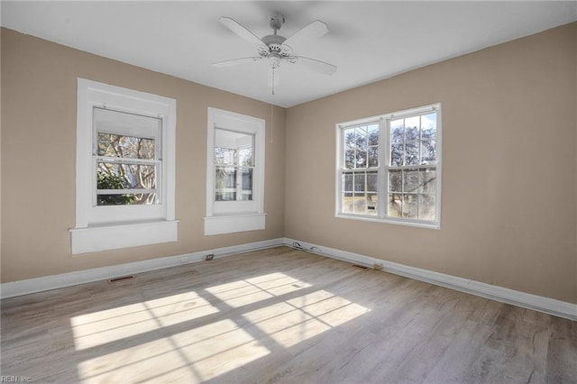 spare room featuring light hardwood / wood-style flooring and ceiling fan