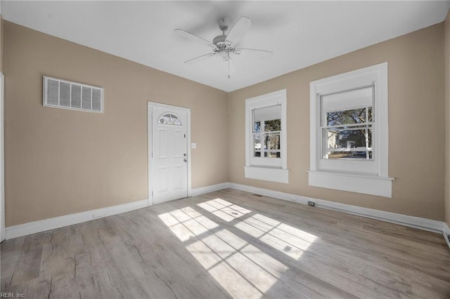 spare room featuring ceiling fan and light hardwood / wood-style floors