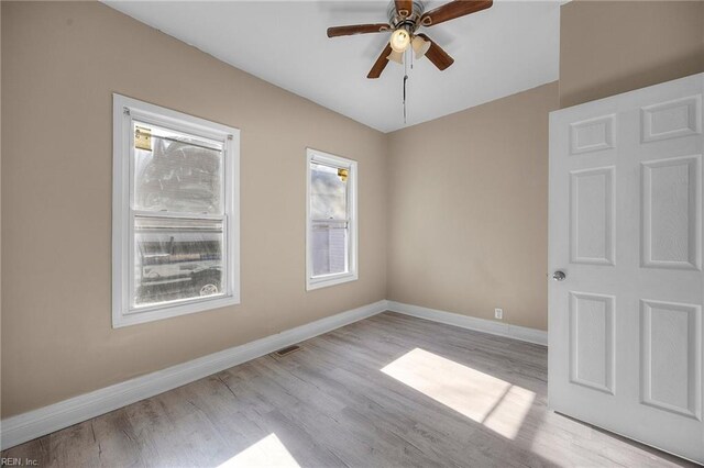 empty room featuring ceiling fan and light hardwood / wood-style floors