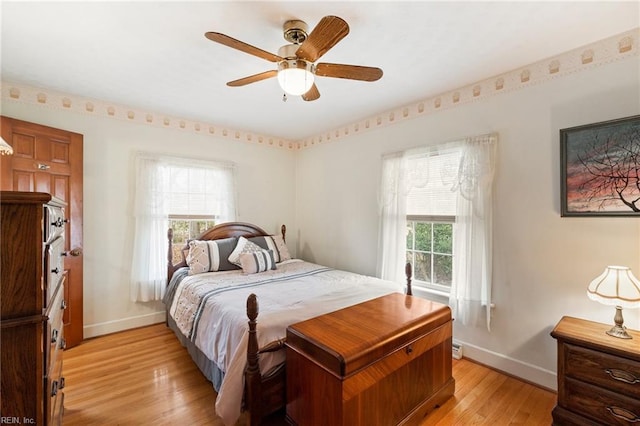 bedroom with ceiling fan and light hardwood / wood-style flooring