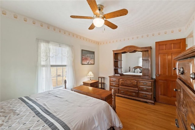 bedroom featuring ceiling fan and light wood-type flooring