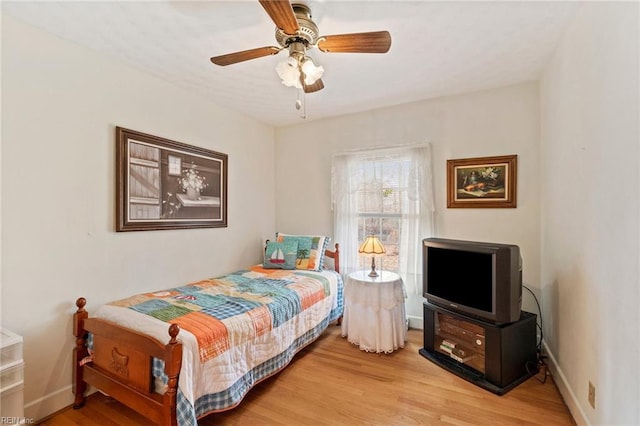 bedroom with ceiling fan and light wood-type flooring