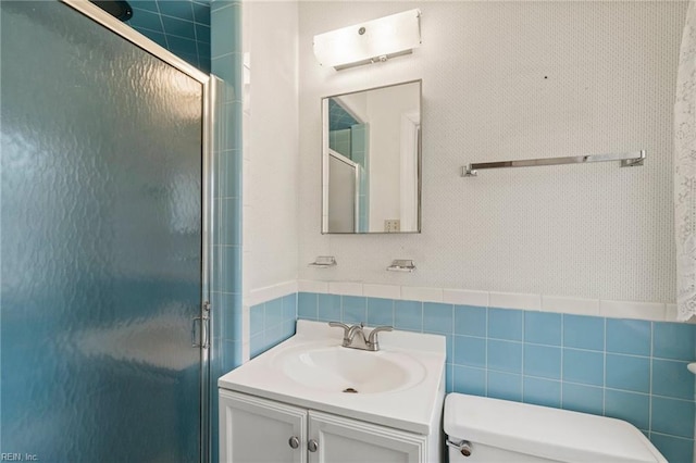 bathroom featuring vanity, toilet, and an enclosed shower