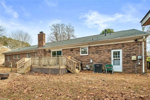 back of house with central AC unit and a deck