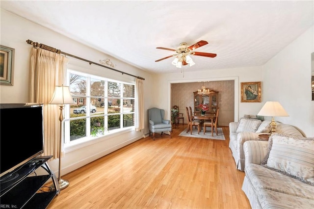 living room featuring ceiling fan and light wood-type flooring