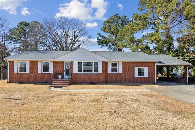 single story home featuring a front lawn and a carport