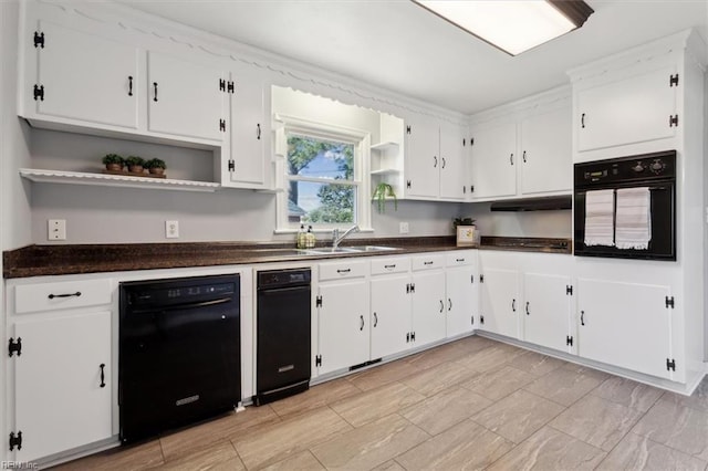 kitchen featuring sink, black appliances, and white cabinets