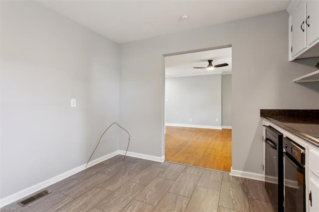 kitchen with white cabinetry, ceiling fan, wall oven, and light hardwood / wood-style flooring