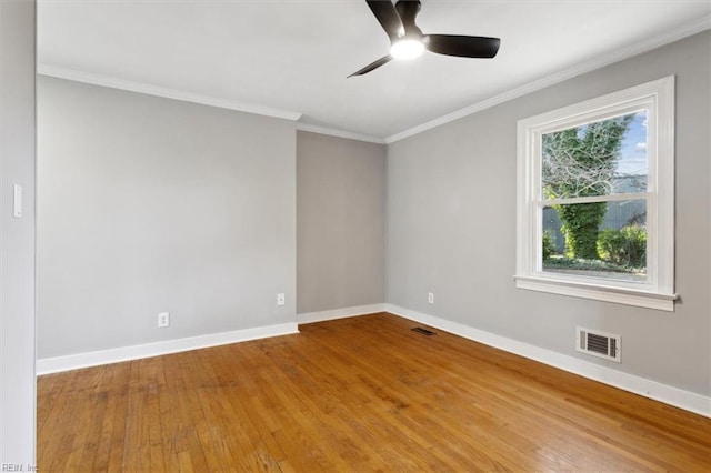 empty room with hardwood / wood-style floors, crown molding, and ceiling fan