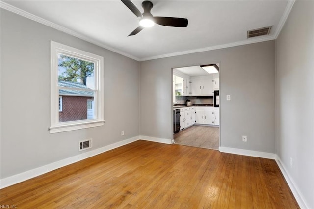 empty room featuring ornamental molding, ceiling fan, and light hardwood / wood-style flooring