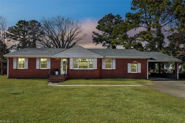 single story home featuring a carport and a yard